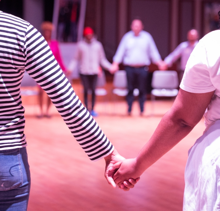 Students holding hands in a healing circle